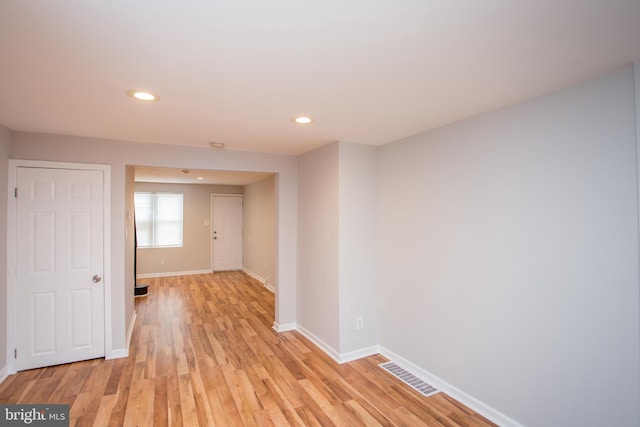 corridor with baseboards, recessed lighting, visible vents, and light wood-style floors