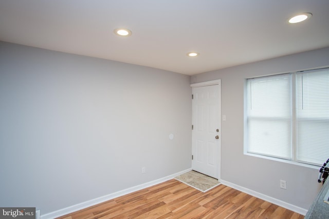 entrance foyer with recessed lighting, light wood-style flooring, and baseboards