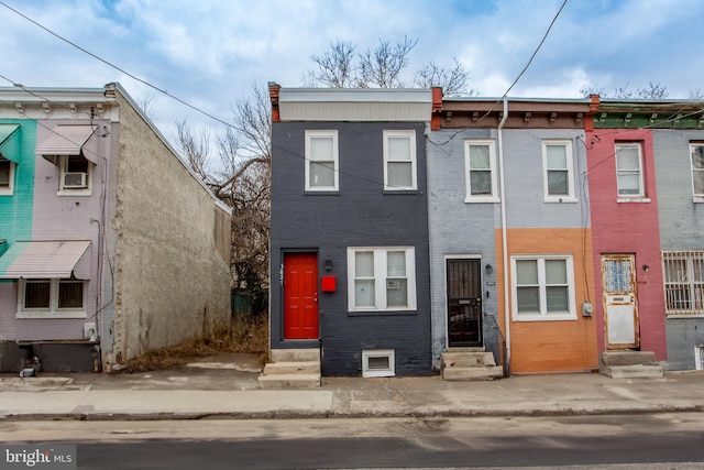 multi unit property featuring entry steps and brick siding