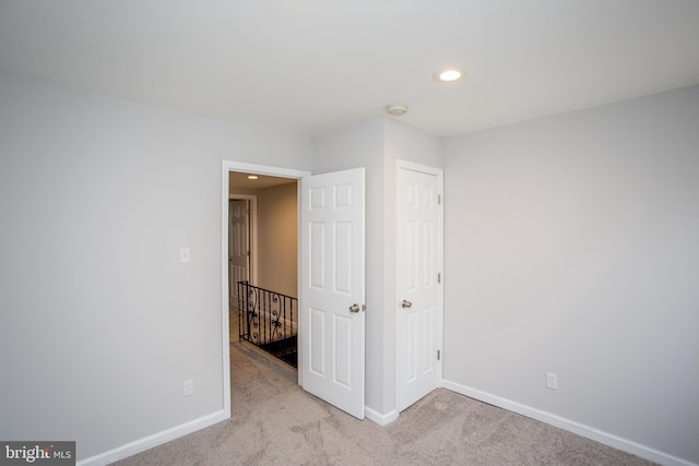 unfurnished bedroom with recessed lighting, carpet, and baseboards