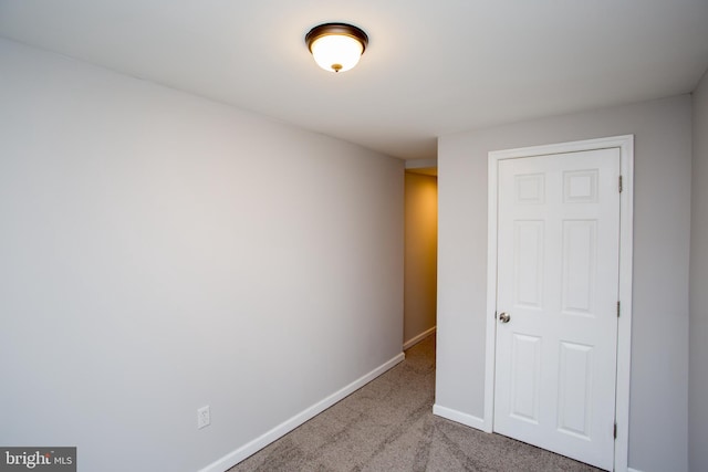 unfurnished bedroom with carpet floors and baseboards