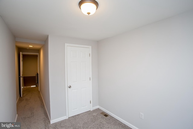 unfurnished bedroom featuring carpet, visible vents, and baseboards