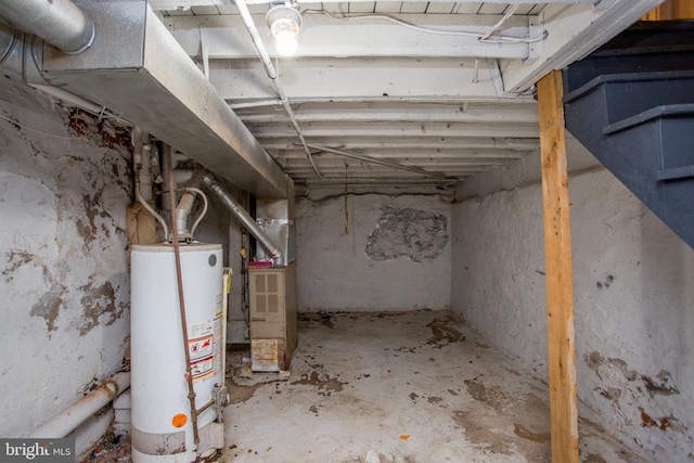 unfinished below grade area with heating unit and gas water heater