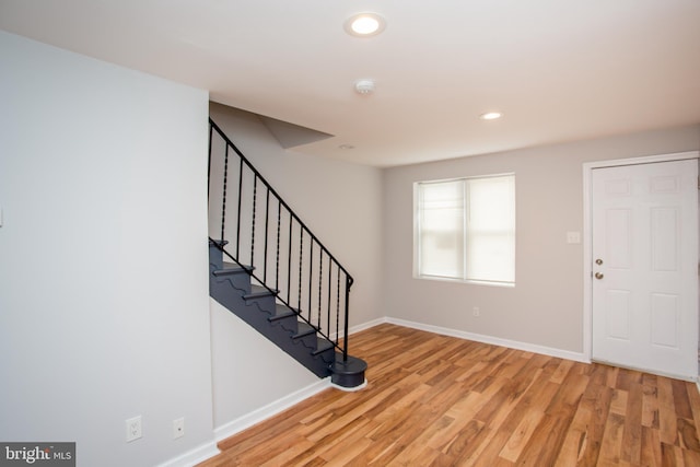 entryway with light wood-style floors, stairs, baseboards, and recessed lighting