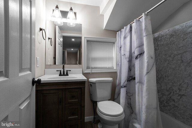 full bath featuring shower / bath combination with curtain, vanity, and toilet