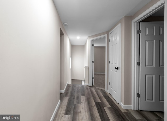 hallway with baseboards and dark wood finished floors