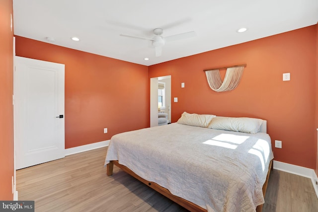 bedroom featuring baseboards, wood finished floors, and recessed lighting