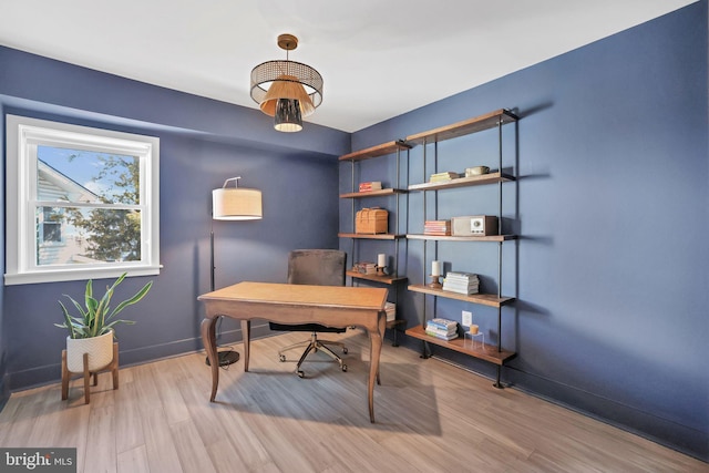 office area with baseboards and wood finished floors