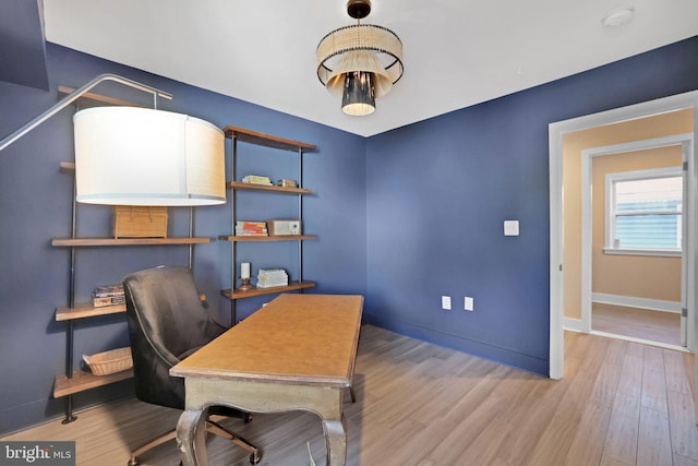 home office featuring baseboards and wood finished floors