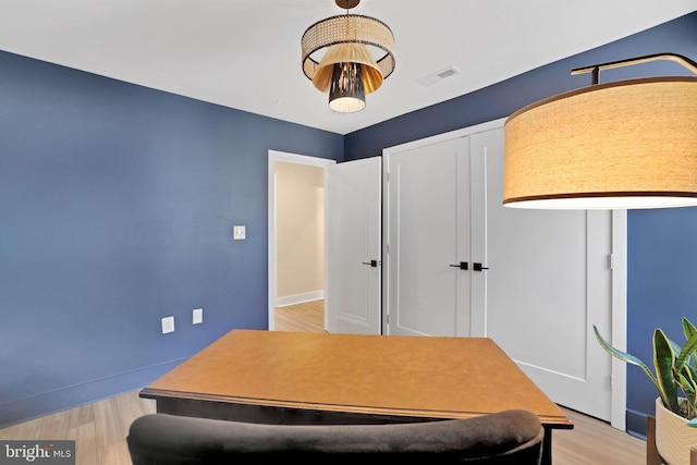 bedroom featuring baseboards, visible vents, a closet, and light wood-type flooring