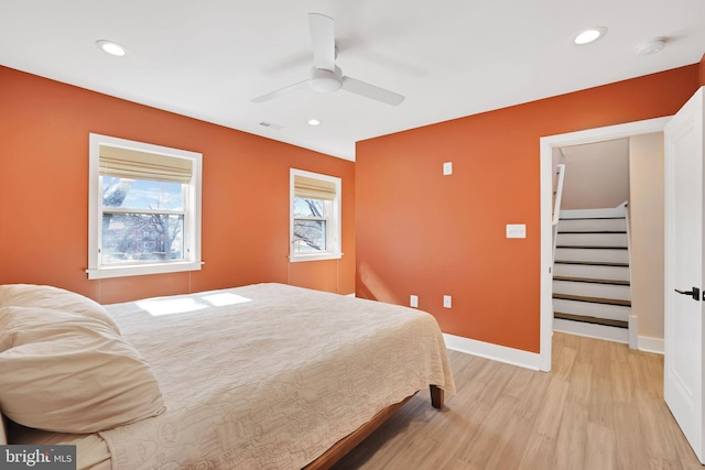 bedroom with a ceiling fan, baseboards, visible vents, light wood-style floors, and recessed lighting