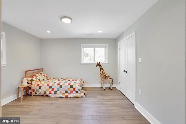 bedroom featuring baseboards, visible vents, recessed lighting, and wood finished floors