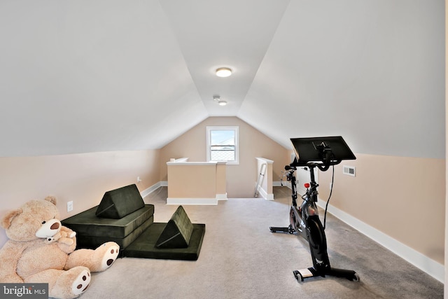 workout room with baseboards, vaulted ceiling, visible vents, and carpet