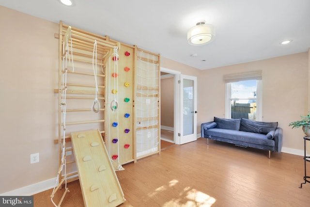 interior space featuring recessed lighting, baseboards, and wood finished floors