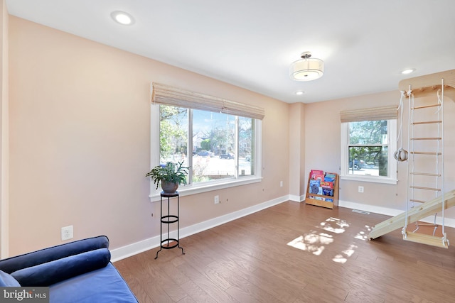 interior space featuring recessed lighting, baseboards, visible vents, and wood finished floors