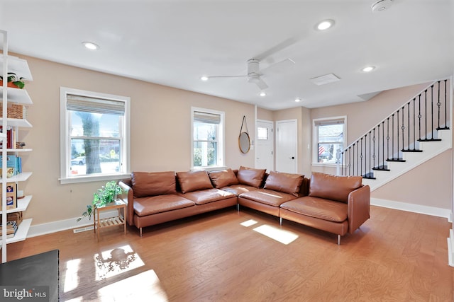 living area featuring baseboards, stairs, ceiling fan, recessed lighting, and light wood-type flooring