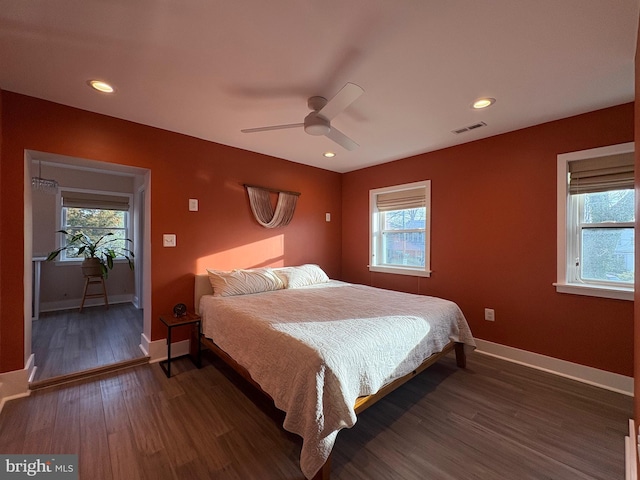 bedroom with recessed lighting, dark wood-type flooring, baseboards, and visible vents