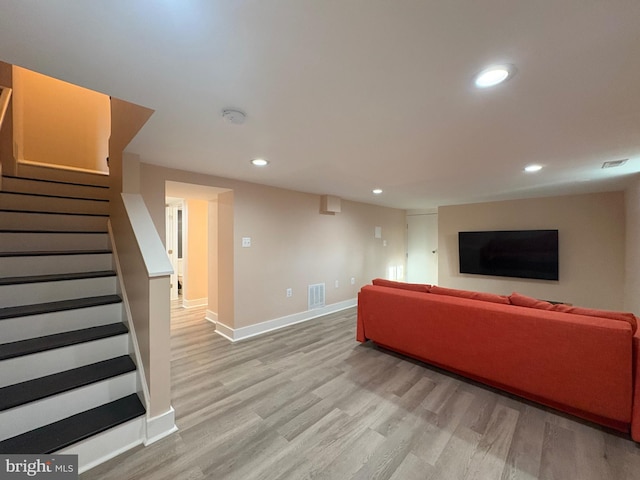 living area featuring stairway, baseboards, visible vents, light wood-style floors, and recessed lighting