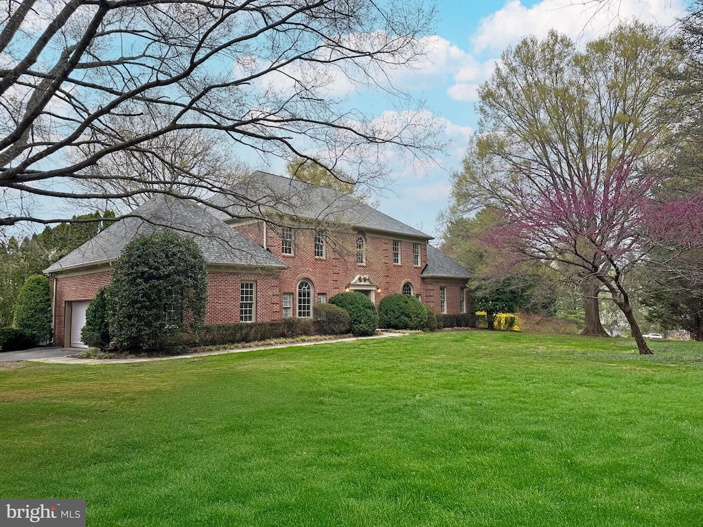 10506 Milkweed Dr, Great Falls, VA 22066 - view of front of property with brick siding, a front lawn, and an attached garage