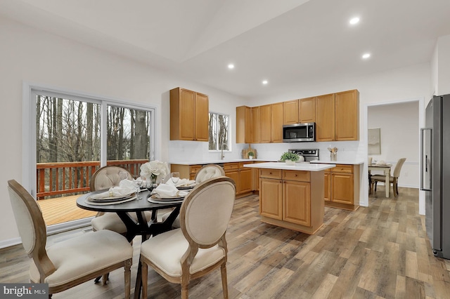 kitchen featuring light countertops, a kitchen island, light wood-type flooring, and stainless steel appliances