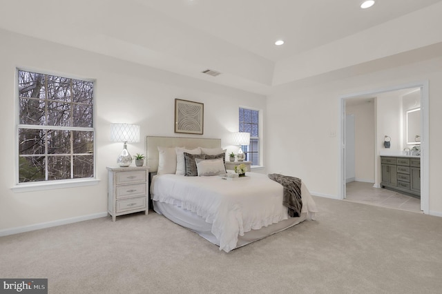 carpeted bedroom with recessed lighting, visible vents, ensuite bathroom, and baseboards