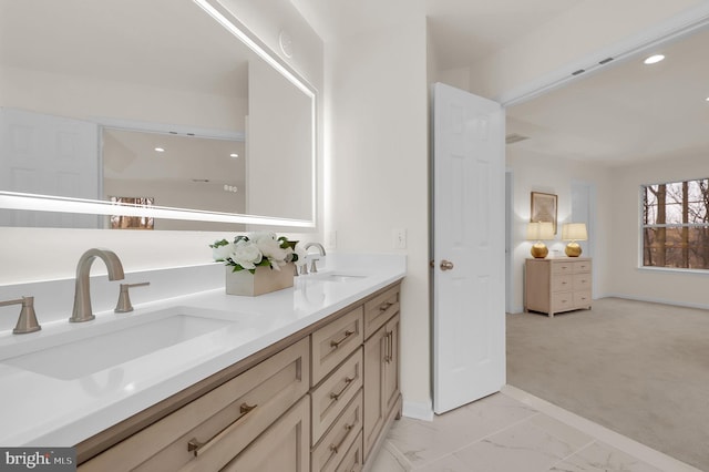 full bath featuring a sink, baseboards, marble finish floor, and double vanity