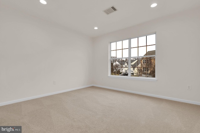 unfurnished room featuring recessed lighting, carpet flooring, visible vents, and baseboards