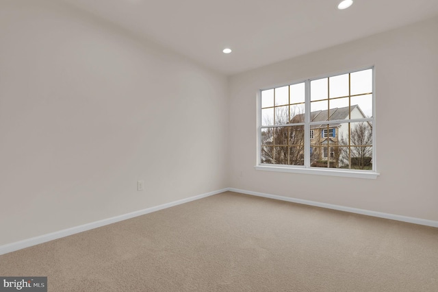 carpeted spare room with recessed lighting and baseboards