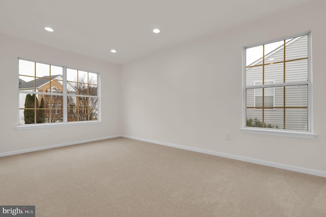 carpeted spare room featuring recessed lighting and baseboards