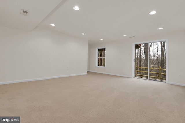 spare room with light carpet, visible vents, recessed lighting, and baseboards