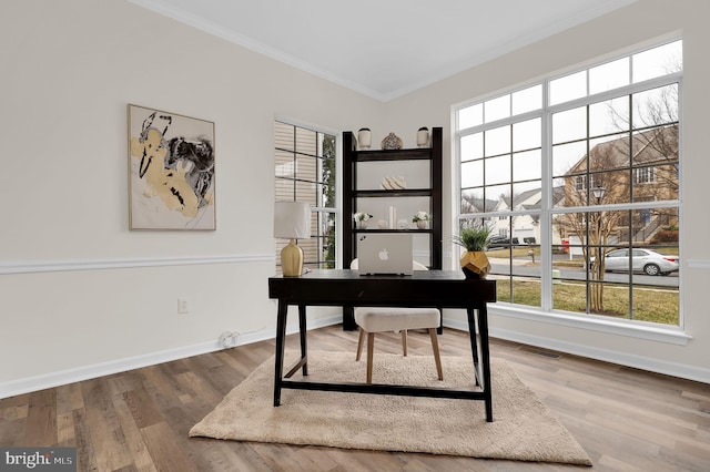 office area featuring visible vents, wood finished floors, baseboards, and ornamental molding