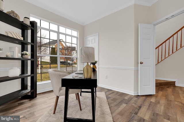 office area with baseboards, wood finished floors, and crown molding