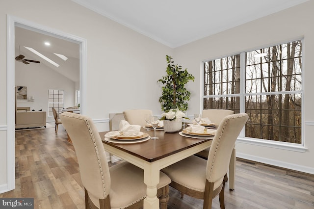 dining room featuring a wealth of natural light, visible vents, wood finished floors, and a ceiling fan