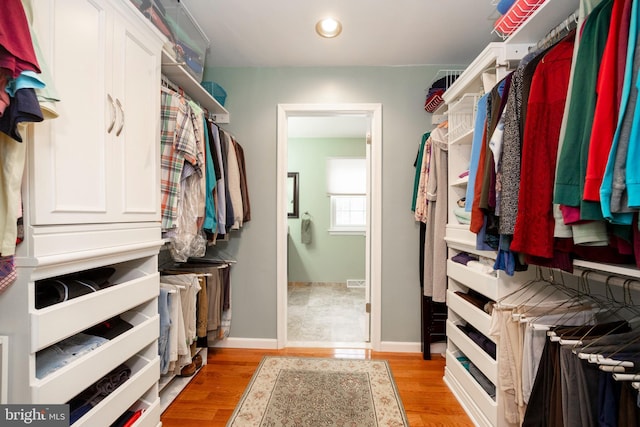 walk in closet featuring light wood finished floors and visible vents