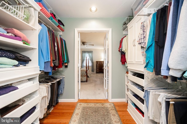 spacious closet with light wood finished floors and ceiling fan