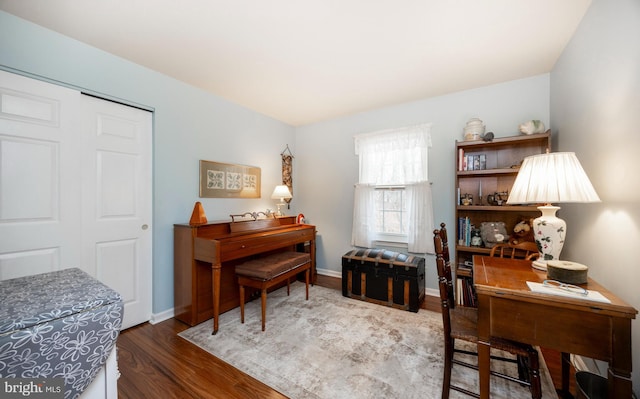 office area with baseboards and wood finished floors