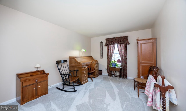 living area with light colored carpet and baseboards