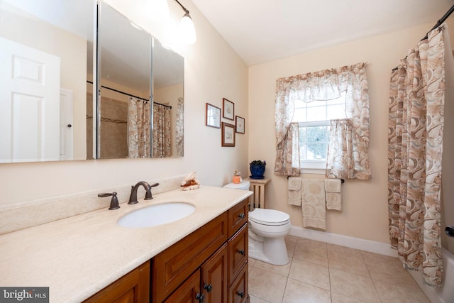 bathroom with toilet, curtained shower, tile patterned flooring, baseboards, and vanity