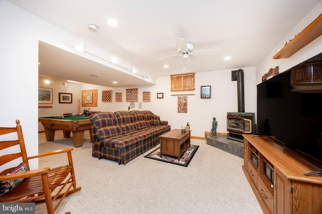 carpeted living room with baseboards, a wood stove, recessed lighting, ceiling fan, and pool table