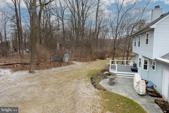 view of yard with a deck and a patio area