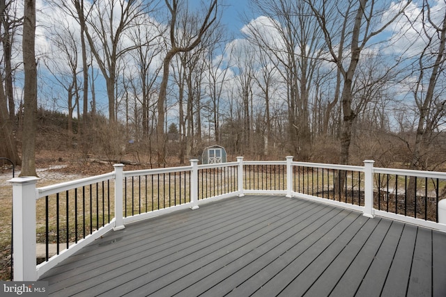 wooden deck with a shed and an outdoor structure