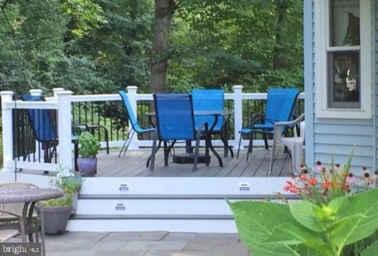 wooden terrace featuring outdoor dining space