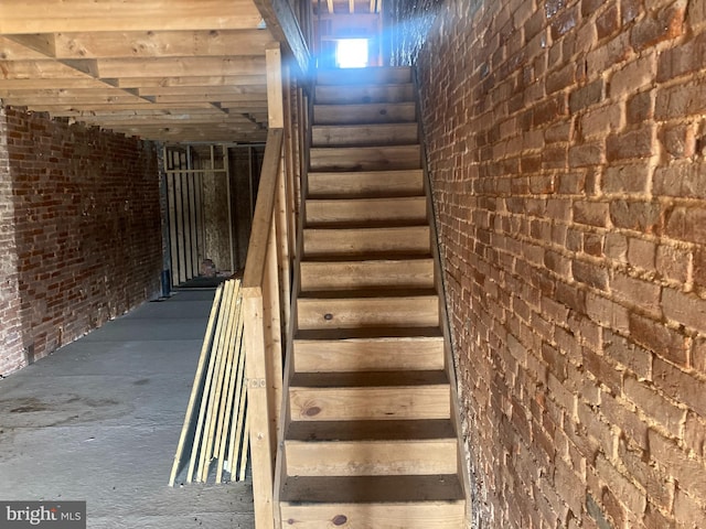 staircase with brick wall