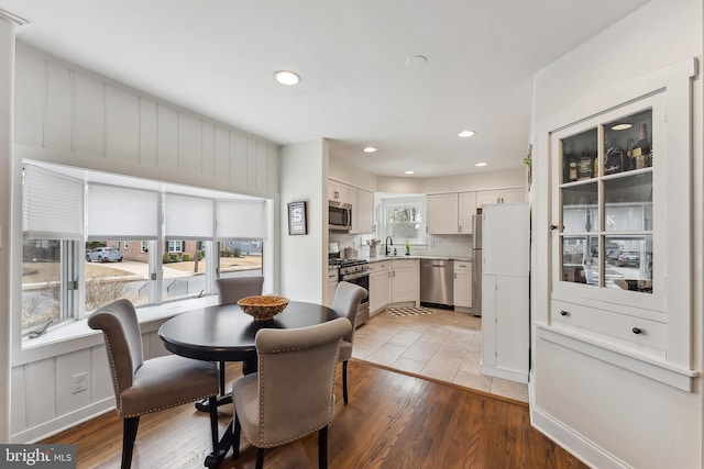 dining space with recessed lighting and light wood finished floors