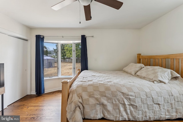 bedroom featuring a ceiling fan and wood finished floors