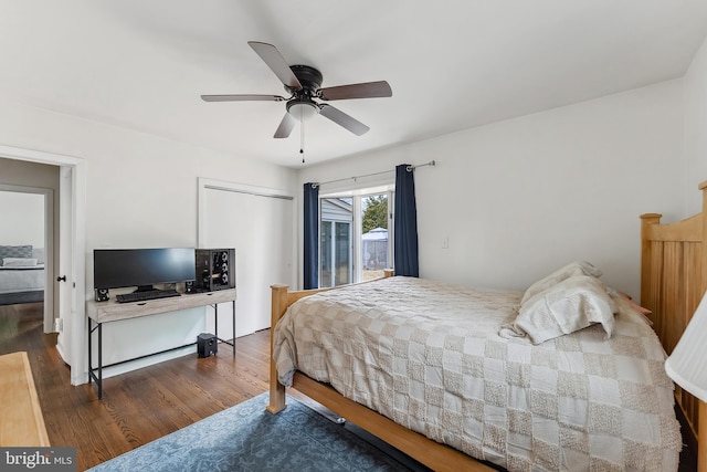 bedroom with a ceiling fan, access to outside, and wood finished floors