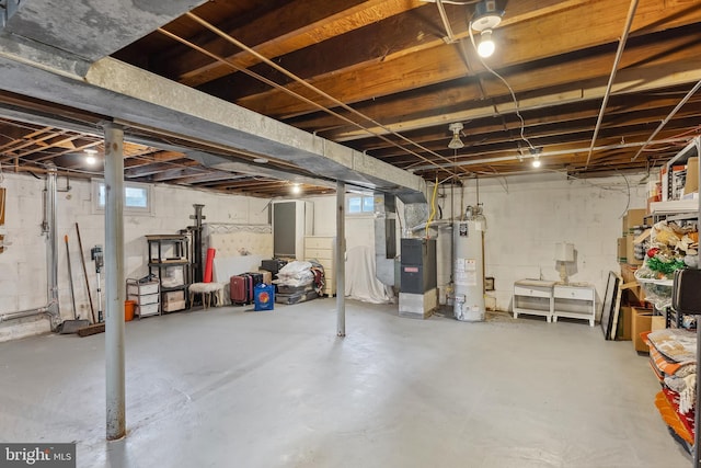 basement with water heater and plenty of natural light