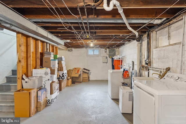 basement with stairway and washing machine and clothes dryer