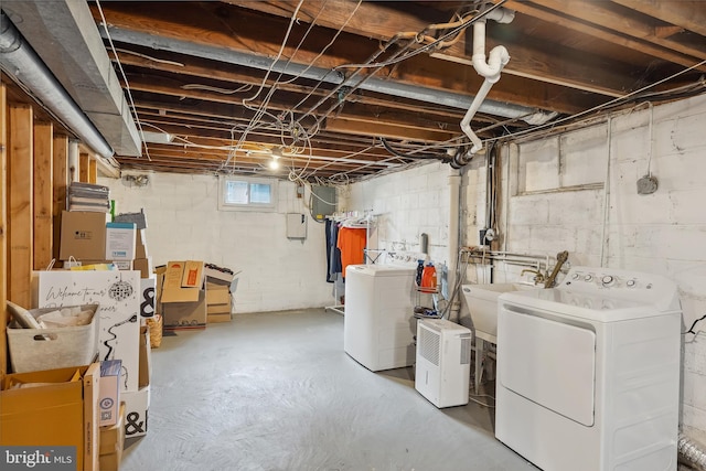 below grade area featuring independent washer and dryer and a sink