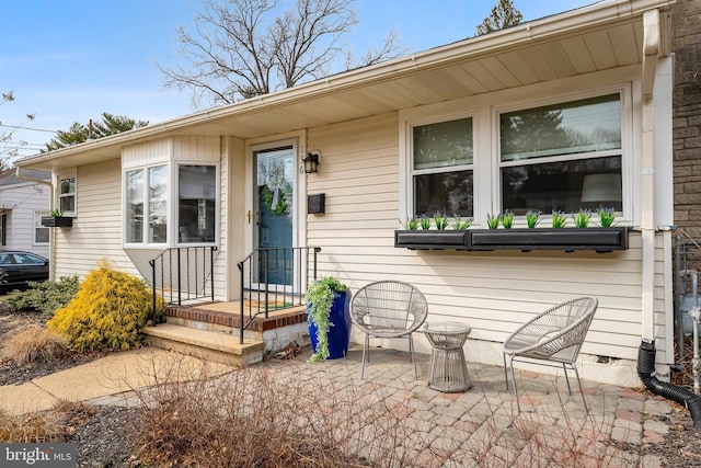 entrance to property featuring a patio area